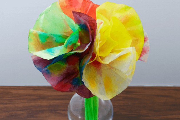 A bouquet of large paper flowers made from coffee filters.