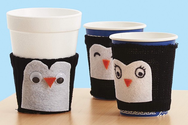 Cups covered with penguin cozies.